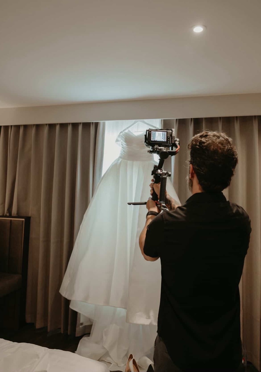 Leo Peres filming the details of a wedding dress